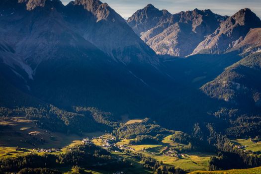Above Idyllic landscape of Scuol Tarasp village at sunrise, Engadine, Swiss Alps, Switzerland