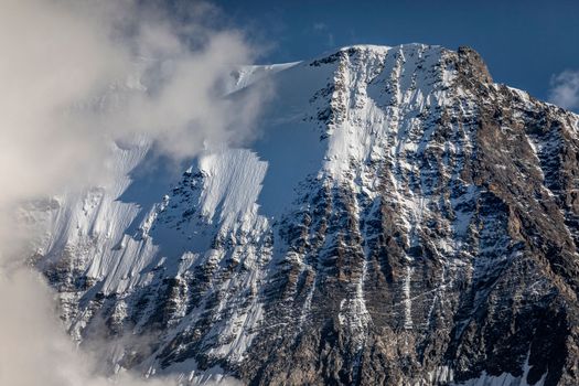 Misty Jungfrau Mountain, Snowcapped Bernese Swiss alps, view from Murren, Switzerland