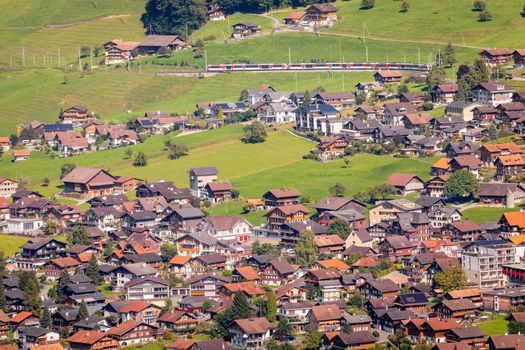 Train and lungern village in the Swiss Alps at sunny day, Switzerland