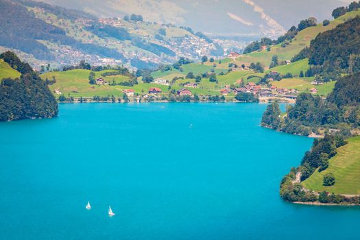 Turquoise Lungernsee and village lungern in the Swiss Alps at sunny day, Switzerland