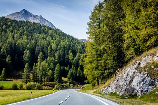 Mountain road in Engadine, dramatic road with swiss alps, Switzerland at sunny day
