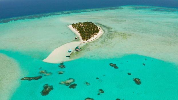 Seascape with beautiful beach and tropical island surrounded by a coral reef from above. Onok Island, Balabac, Philippines. Summer and travel vacation concept