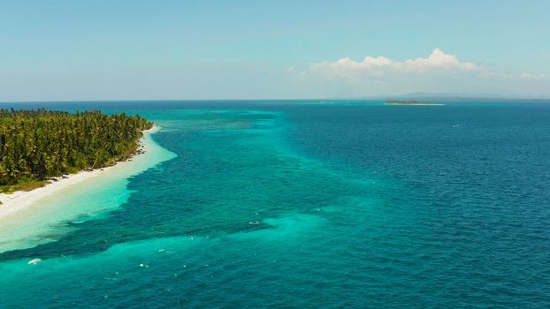 Sandy beach and tropical island by atoll with coral reef, top view. Patongong Island with sandy beach. Summer and travel vacation concept.