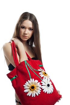 Yong woman portrait with red beach bag with flowers isolated