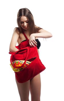 Woman search in red beach bag with towel isolated