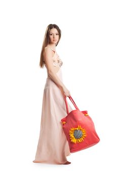 Beauty young woman walk in rose dress and red beach bag isolated