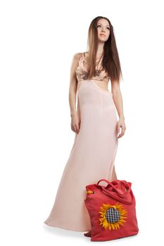 Beauty girl with long hair walk in rose dress and red beach bag isolated