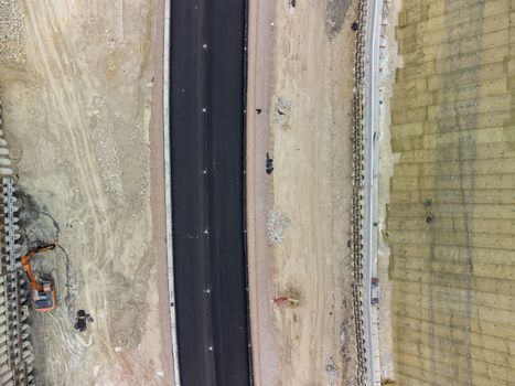 Aerial drone shot Road construction in progress in wild nature canyon.
