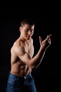 young naked man in jeans portrait posing in dark