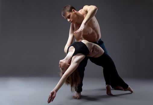 Couple of young gymnast posing in dance performance isolated