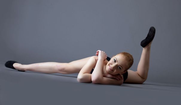 funny gymnast girl in black top lay on ground - black tank top and shirt
