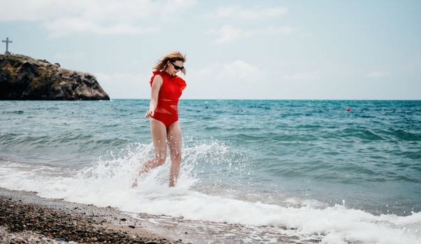 Young happy woman walks carefree on the seaside . Portrait beautiful young woman relax smile around beach sea ocean in holiday vacation travel trip