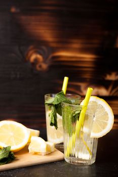 Refreshing lemonade made of fresh lemons on vintage wooden background