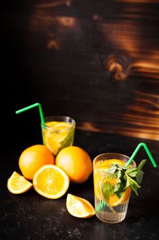 Fresh homemade healthy and delicious orangeade on vintage wooden background