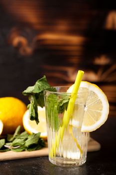 Natural lemonade made of organic lemons and mint on vintage wooden background