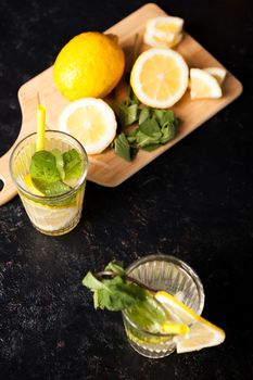 Healthy and delicous detox water with lemons on vintage wooden background