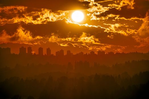 Dramatic sunset over Metrotown in Vancouver. Urban cityscape silhouette on sunset sky background