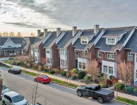 Residential area of Queensborough community with the row of townhouses along the street.