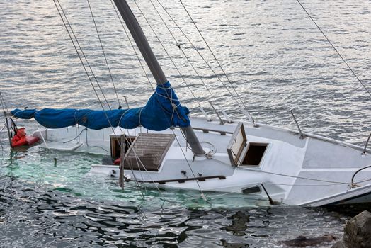 White yacht drowned in Pacific Ocean bay.