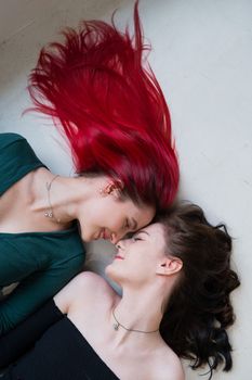 Top view of two women lying side by side. Lesbian intimacy