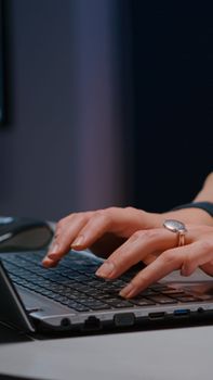 Close-up of businesswoman hands on keyboard sitting at desk in startup company office planning economic project on internet. Executive manager typing financial statistics answering business email
