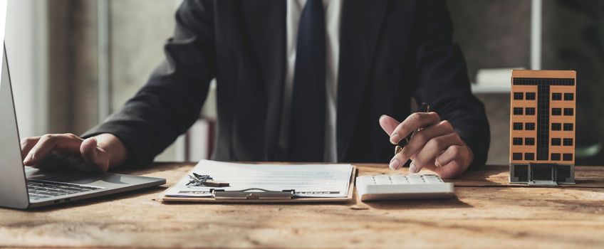 Entrepreneurs, business owners, accountants, real estate agents, A young man using a calculator to calculate his home budget to assess the risks of investing in real estate...