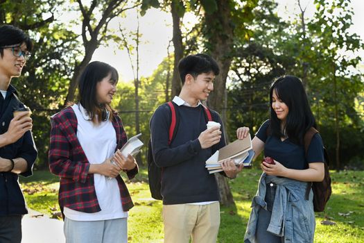 University students walking and talking each other in a campus. University, youth lifestyle and friendship concept.