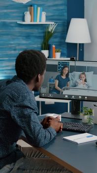 Black man talking with his family who is in hospital ward, using intenet web online teleconference video call to connect with loved ones. Webcam app remote screen healthcare consultation