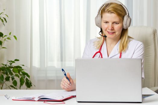 Online consultation doctor. Virtual doctor visit, telemedicine healthcare concept,young female doctor giving advice over laptop.