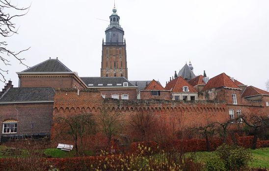 The medieval town wall of Zutphen, the Netherlands. In the background the tower of the Saint Walpurga church. The skyline of this hanseatic city