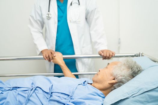 Doctor touching hands Asian senior or elderly old lady woman patient with love, care, encourage and empathy at hospital.
