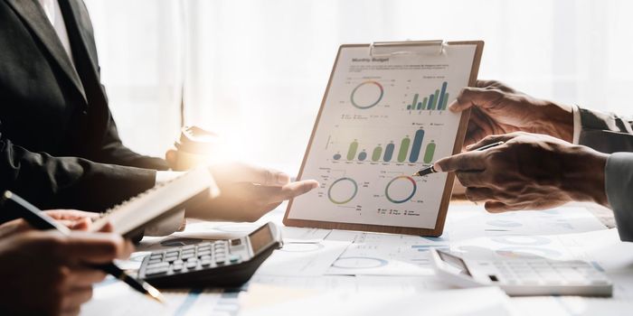 Asian business adviser meeting to analyze and discuss the situation on the financial report in the meeting room.Investment Consultant, Financial advisor and accounting concept...