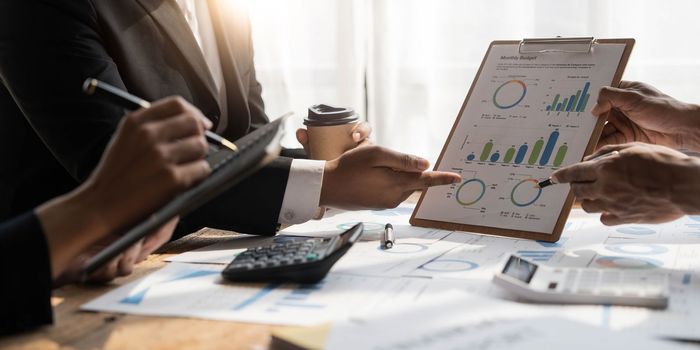 Asian business adviser meeting to analyze and discuss the situation on the financial report in the meeting room.Investment Consultant, Financial advisor and accounting concept...