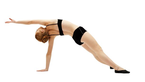 young woman training in black top on white isolated