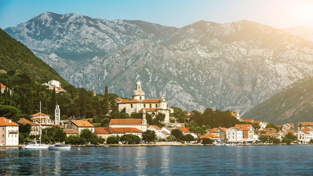 Beautiful city in Adriatic sea in Montenegro with mountains view. Scenic town with nature landscapes and Mediterranean architecture