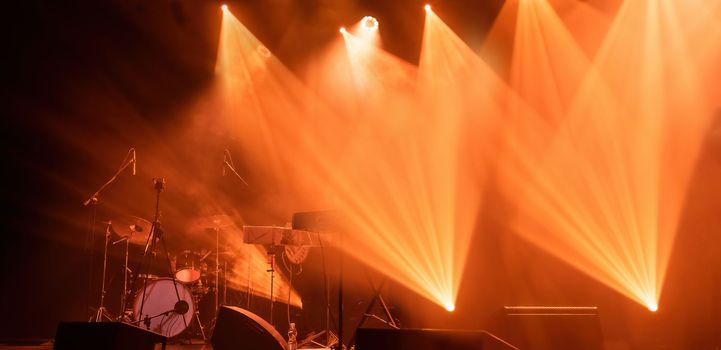 Light on a free music stage, rock group scene with spotlights in fog