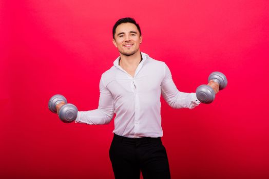 Business man with fitness dumbbells wear shirt. Studio shoot on red background