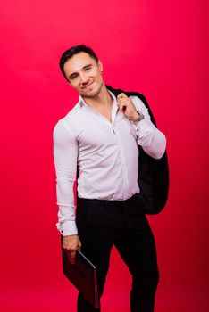Cheerful young guy 20s in classic shirt isolated on a bright red wall background studio portrait.