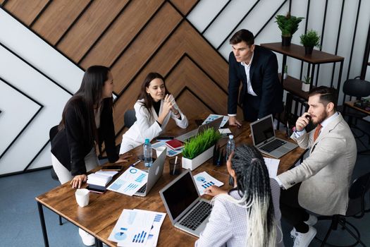 business meeting in the office on the background of a large table with laptops.