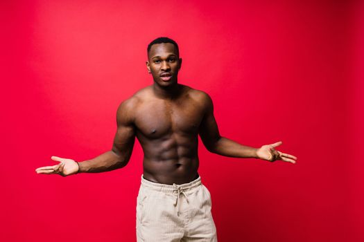 Smiling young african american man guy isolated on yellow background studio. People sincere emotion