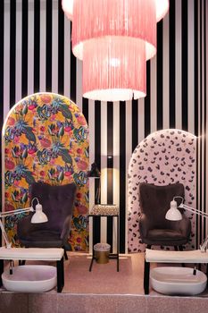 vertical photo of a manicure and pedicure room in a beauty salon, empty professional dermatologist's room waiting for customers, wellness and body care concept