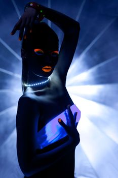 Girl with ultraviolet make-up disco dance in dark