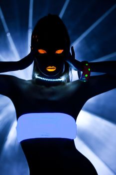 Girl with ultraviolet make-up disco dance in dark