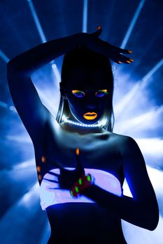 Girl with ultraviolet make-up disco dance in dark