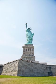 Liberty Statue, a landmark of new york city, with blue sky