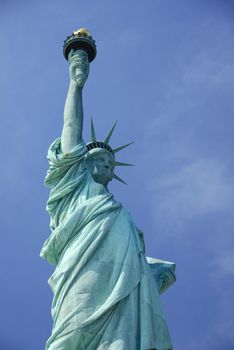 Liberty Statue, a landmark of new york city, with blue sky