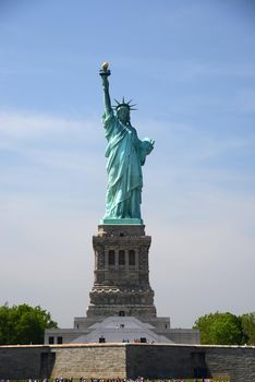 Liberty Statue, a landmark of new york city, with blue sky