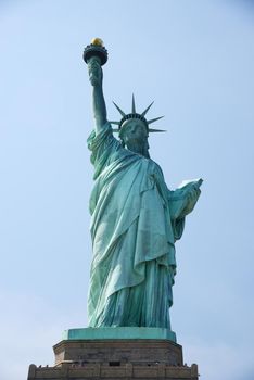 Liberty Statue, a landmark of new york city, with blue sky