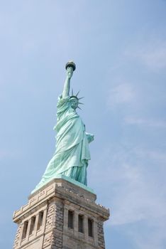 Liberty Statue, a landmark of new york city, with blue sky