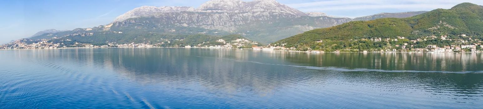 Panoramic view of Bay of Kotor from the sea surrounded by mountains in Montenegro, one of the most beautiful bay in the world.